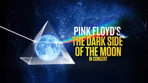 Espectáculo de luces y láser en un concierto, con el icónico prisma de Pink Floyd, celebrando The Dark Side of the Moon.